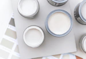 6 cans of neutral paint colors in various shades of white