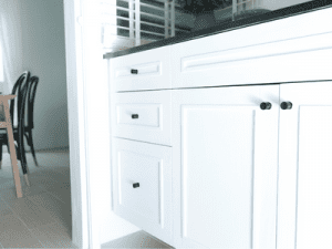 White kitchen cabinets after being painted and restored