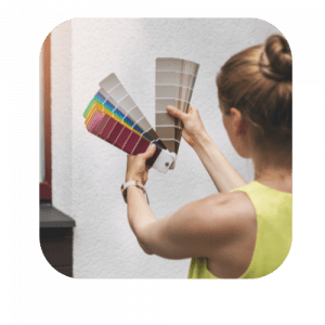Woman choosing paint colors with a color fan deck