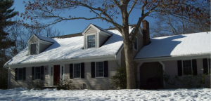 Duxbury Massachusetts home in he wintertime with snow on the ground.