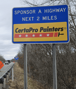 Blue Sponsor a highway sign with Gold CertaPro Painters Logo on it near interstate 95 in Dartmouth area.