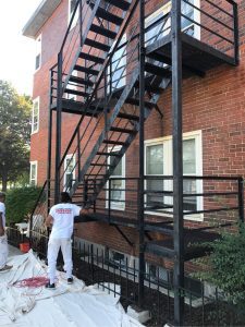CertaPro Painter working on a fire escape