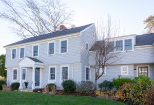 View of colonial home painted gray