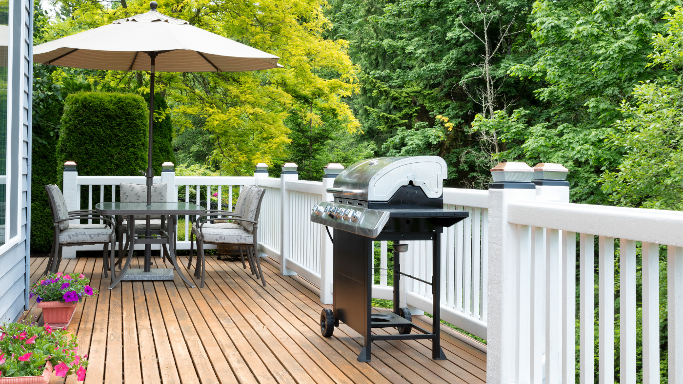 Stained deck with furniture and grill