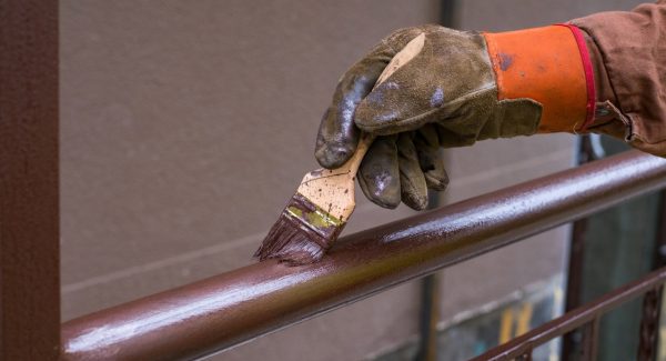 Railing getting painted brown by painter