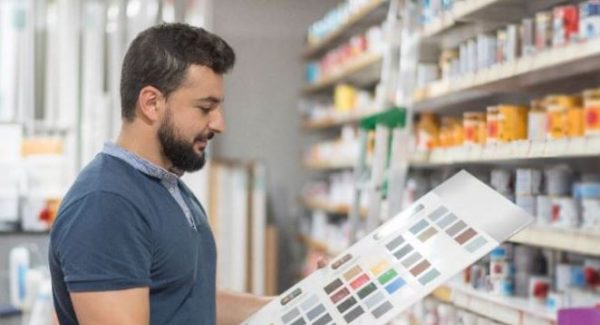 man in store reviewing paint product options