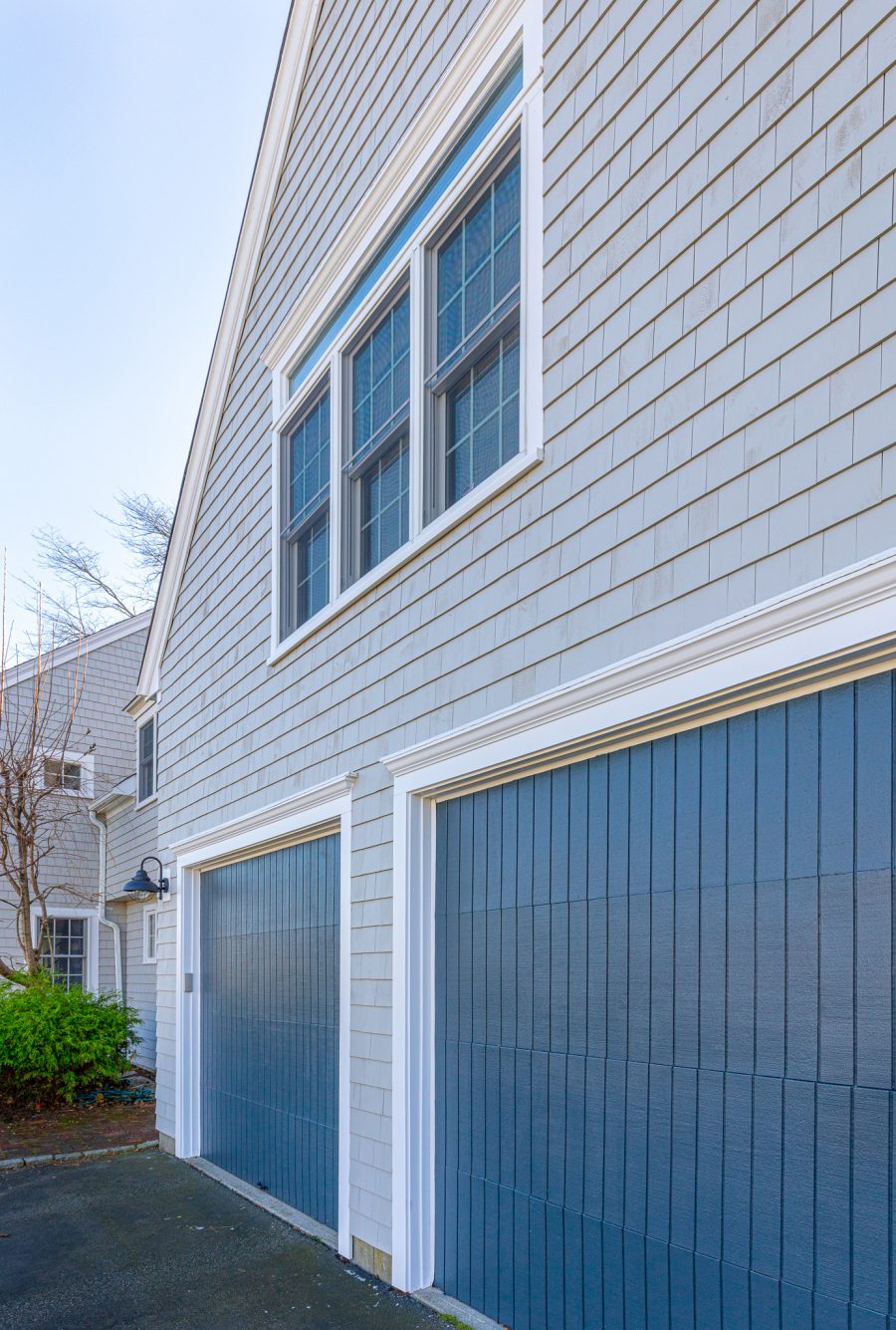 Blue painted garage doors with white trim. Preview Image 6