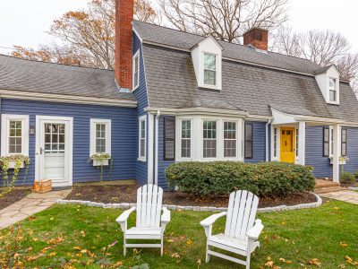 blue and white painted home with yellow front door