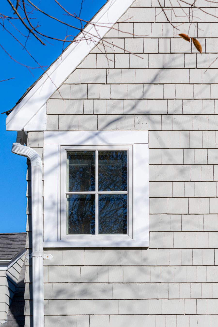 Close up view of painted roof trim, and stained cedar shingle siding Preview Image 11