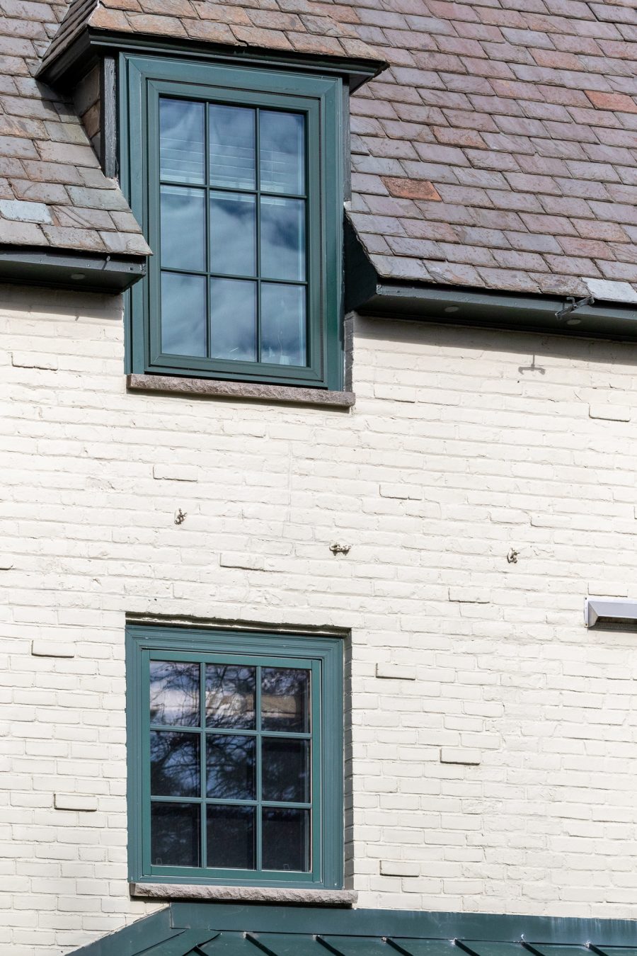 White painted brick exterior with green window trim Preview Image 6