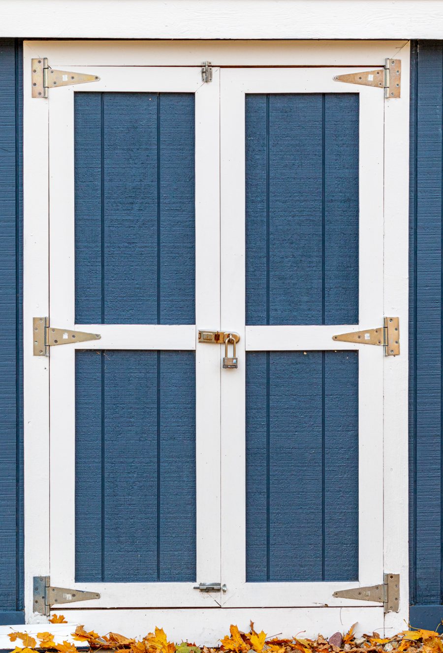 Shed door with white trim and blue siding Preview Image 3