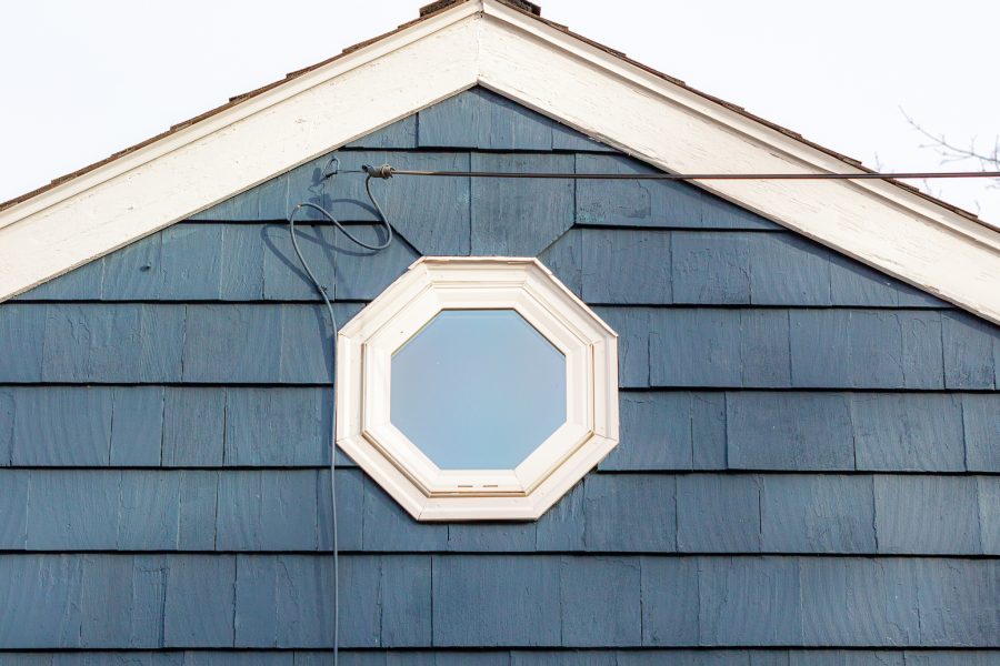 attic window with white trim and blue stained cedar siding Preview Image 5