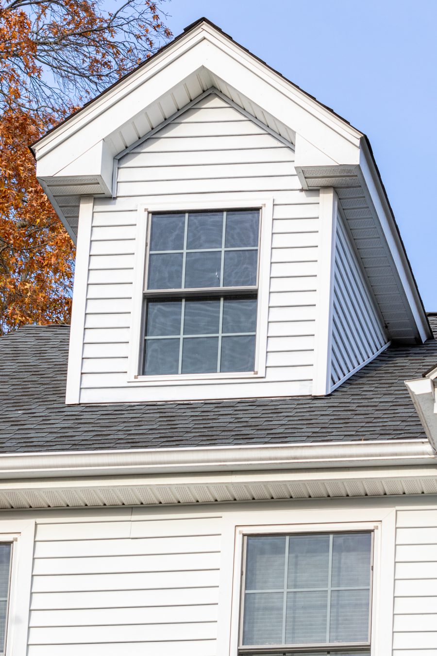Dormer on home with white painted siding and trim. Preview Image 4
