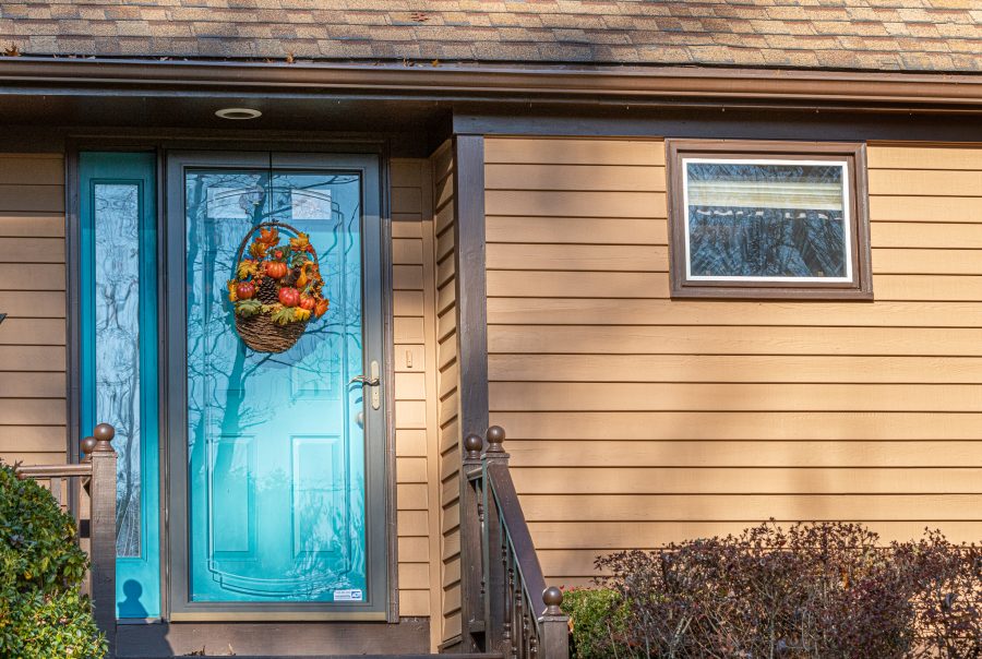 Teal front door on brown exterior home. Preview Image 6