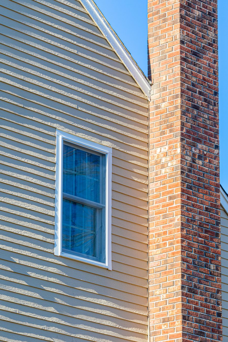 Siding, window, and chimney closer view on painted home Preview Image 4