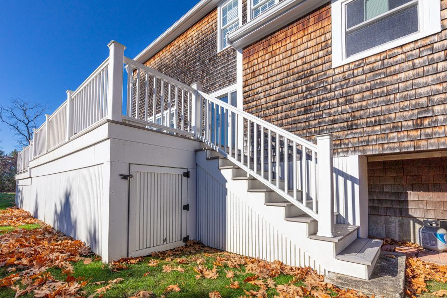 White painted deck on home with cedar shingle exterior. Preview Image 1