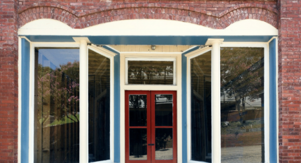 Blue painted storefront with red door and white trim
