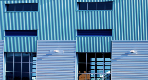 Turquoise and light blue corrugated metal panel siding on commercial building