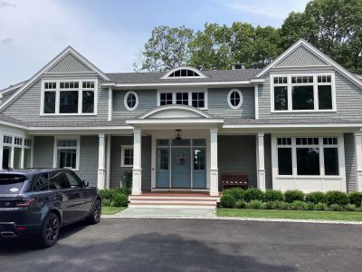 Beautiful gray home in Duxbury painted gray with white trim.