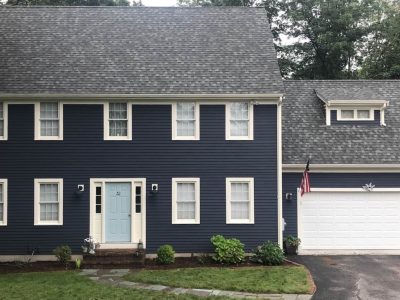 Dark blue home Weymouth Massachusetts with light blue door and white trim