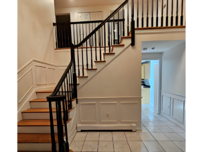 Foyer and staircase with black railing