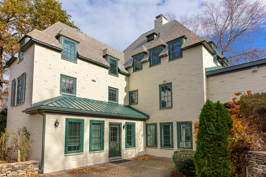 back entrance of home with green painted door and white brick Preview Image 1