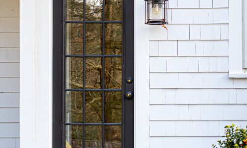 White Exterior With Black Door