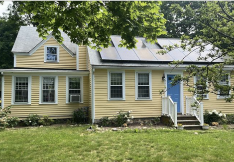 Yellow home with bright blue door on South Coast, Massachusetts