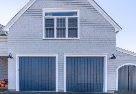 Blue painted garage doors on side of home.