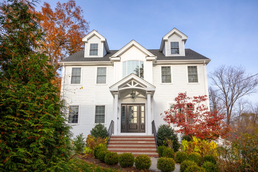 Full view of newly painted house exterior, white siding and trim. Preview Image 3