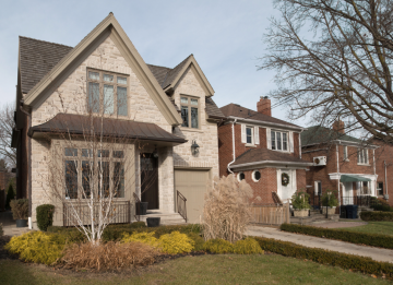 painted brick home next to unpainted brick houses