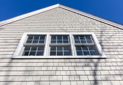 Three windows on side of home with white painted trim.