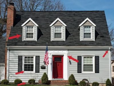 Gray cape home with arrows showing areas of wood rot