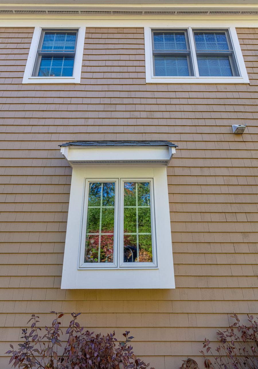 Tan stained cedar shingles with white painted window trim. Preview Image 6