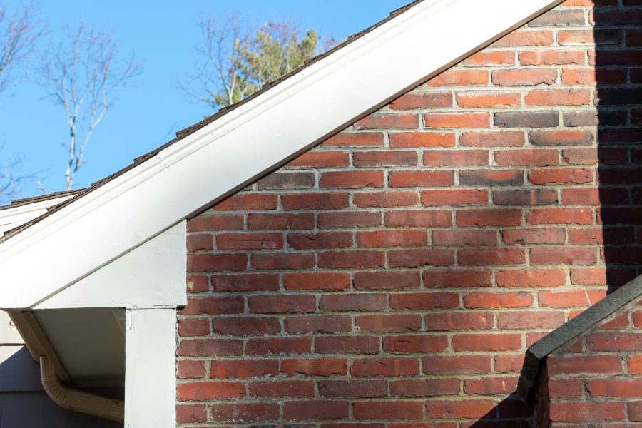 White painted roof trim on brick home. Preview Image 8