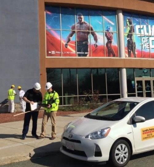 White car in front of movie theater