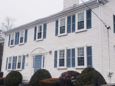 white painted house 4 bedroom coloinial with black shutters and a blue front door