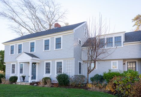 Front of cedar shingle home after staining and painting project.