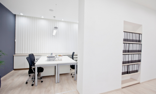 White office with wainscot and built-ins