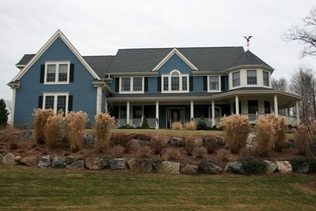 Blue house with black shutters on hill
