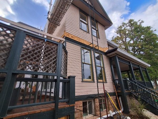 side view of house with wrap porch during painting Preview Image 7