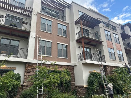 ladders against commercial building during repaint