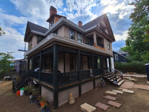 front view of house with wrap porch during painting Preview Image 13