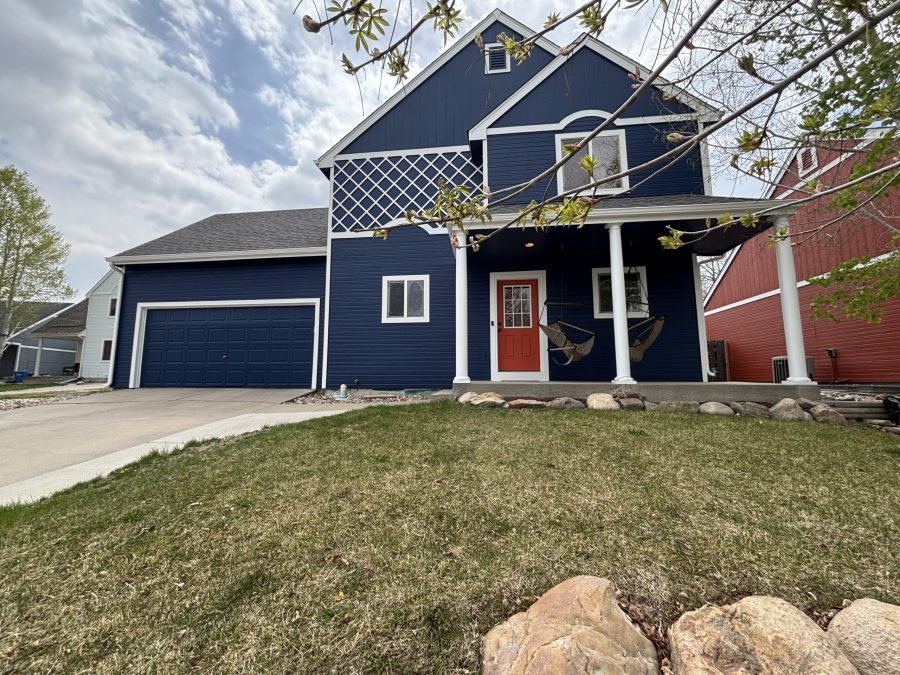 blue painted house with white trim and red door Preview Image 1