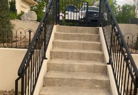 concrete staircase with metal railing