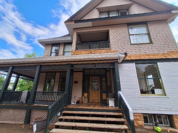 front view of house with wrap porch during painting Preview Image 14