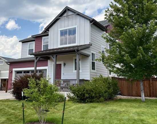 front of house with painted red and soft grey siding