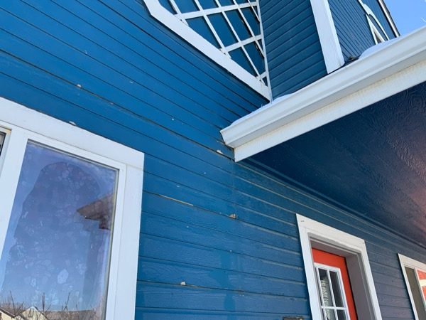 blue house with damaged paint Preview Image 6
