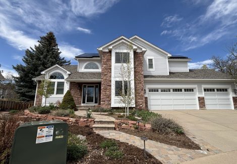 front exterior of house with stone and painted siding