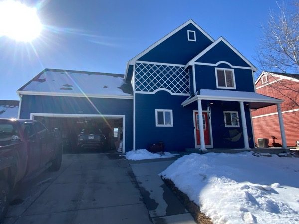 blue painted house with white trim and red door Preview Image 4